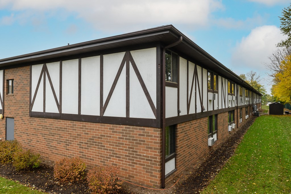 the front of a brick building with awning and windows