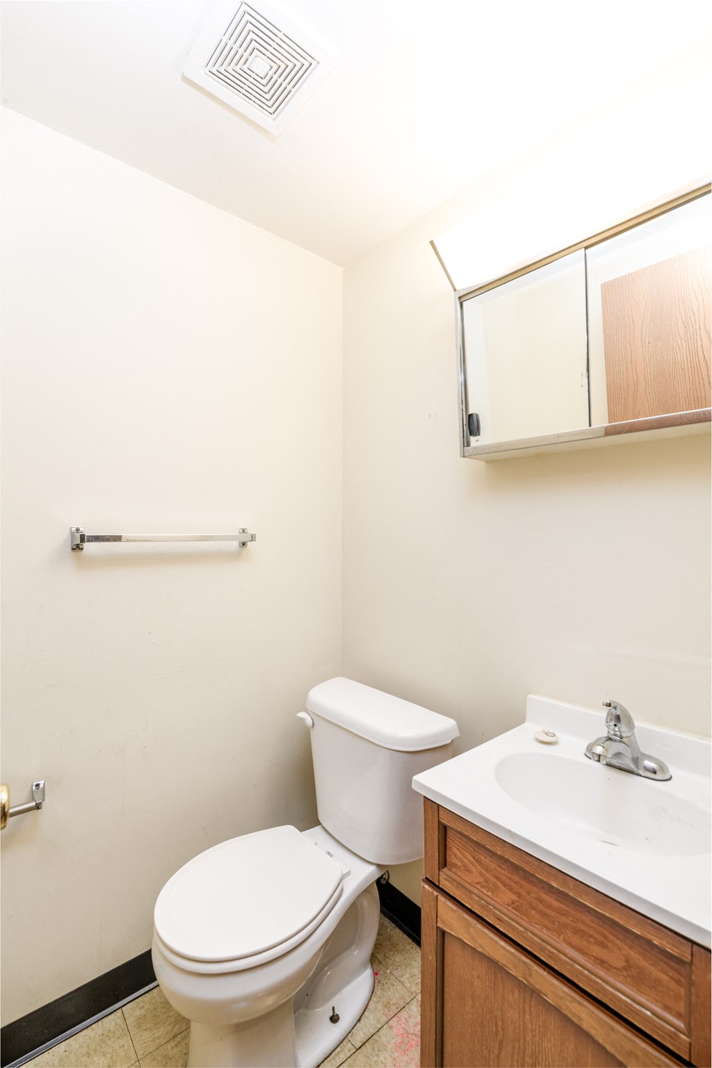 a bathroom with a toilet and a sink and a mirror
