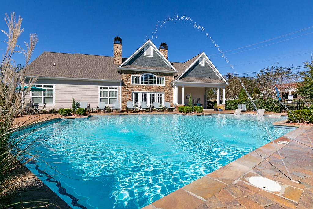 a large swimming pool in front of a house