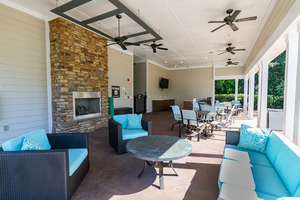 the preserve at ballantyne commons covered patio with furniture and a fireplace