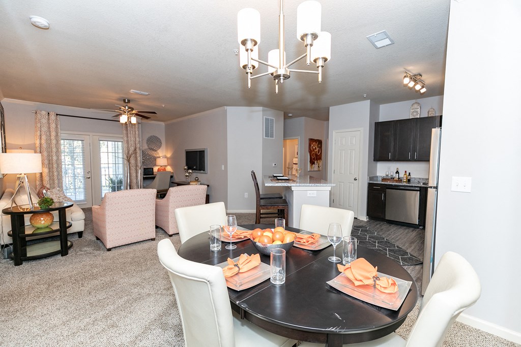 a dining room and living room with a table and chairs