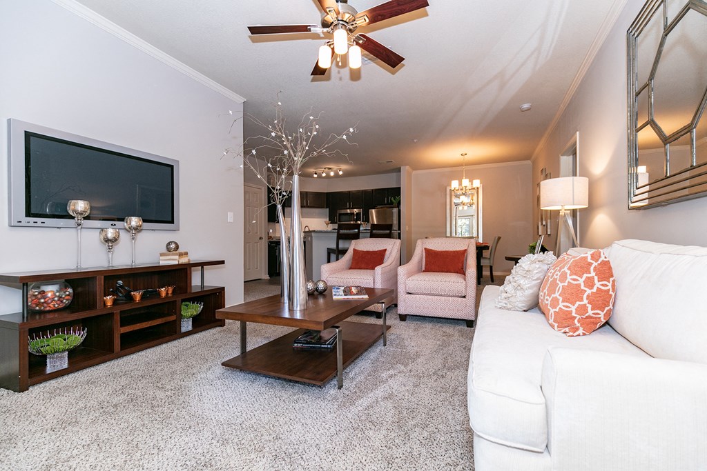 a living room with a white couch and a tv