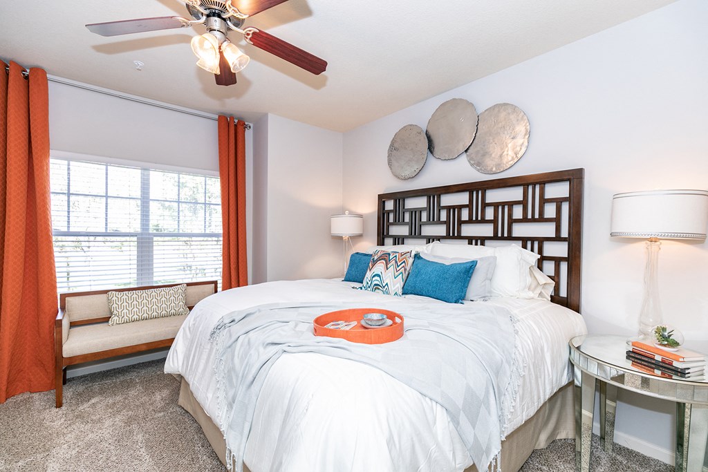 a bedroom with a large bed and a ceiling fan
