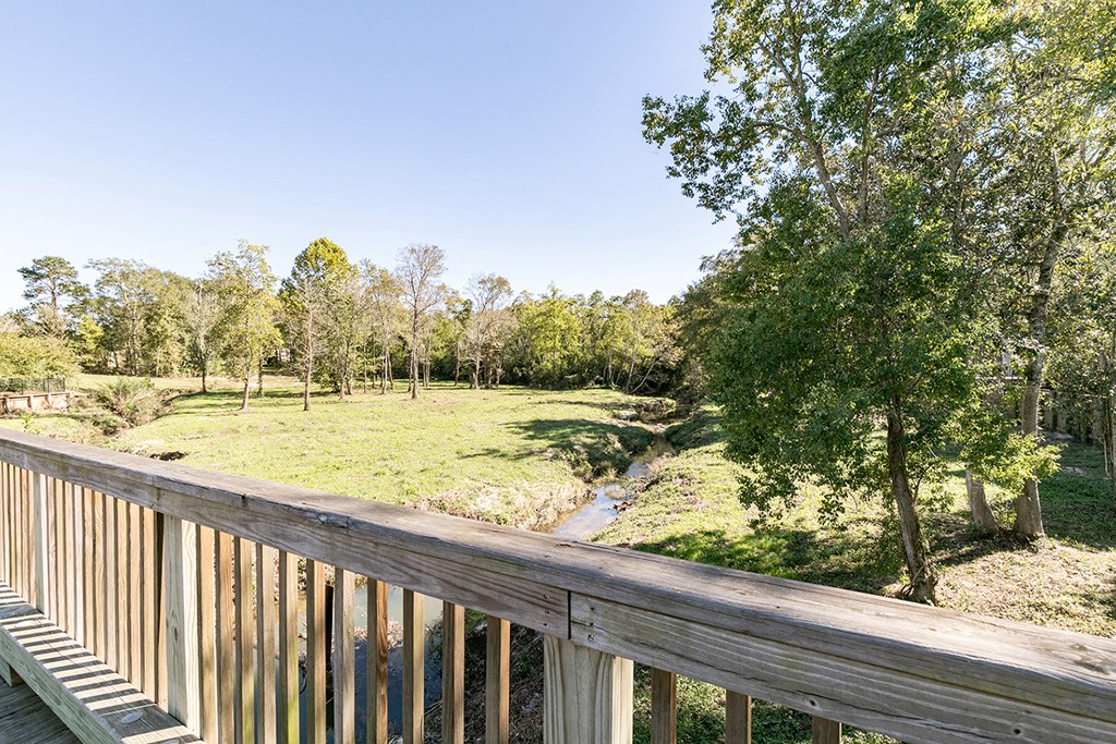 the view from the deck of a cabin with a river and trees