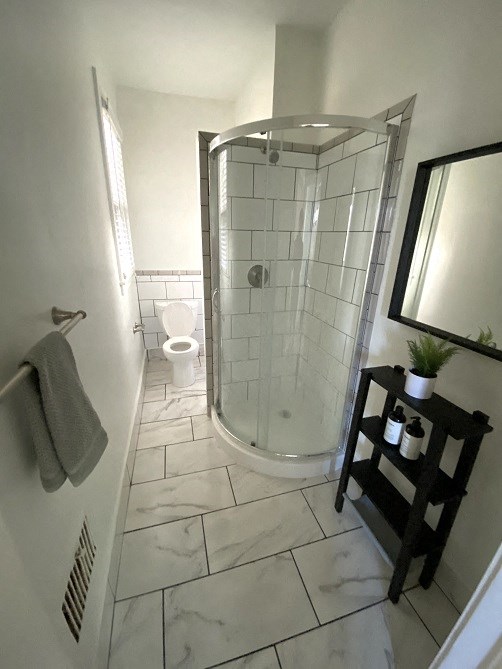 a bathroom with a shower and a toilet in it