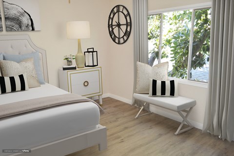 a bedroom with a bed and a chair and a window