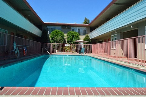 a large swimming pool in front of a building