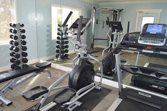 the gym has a lot of equipment in it