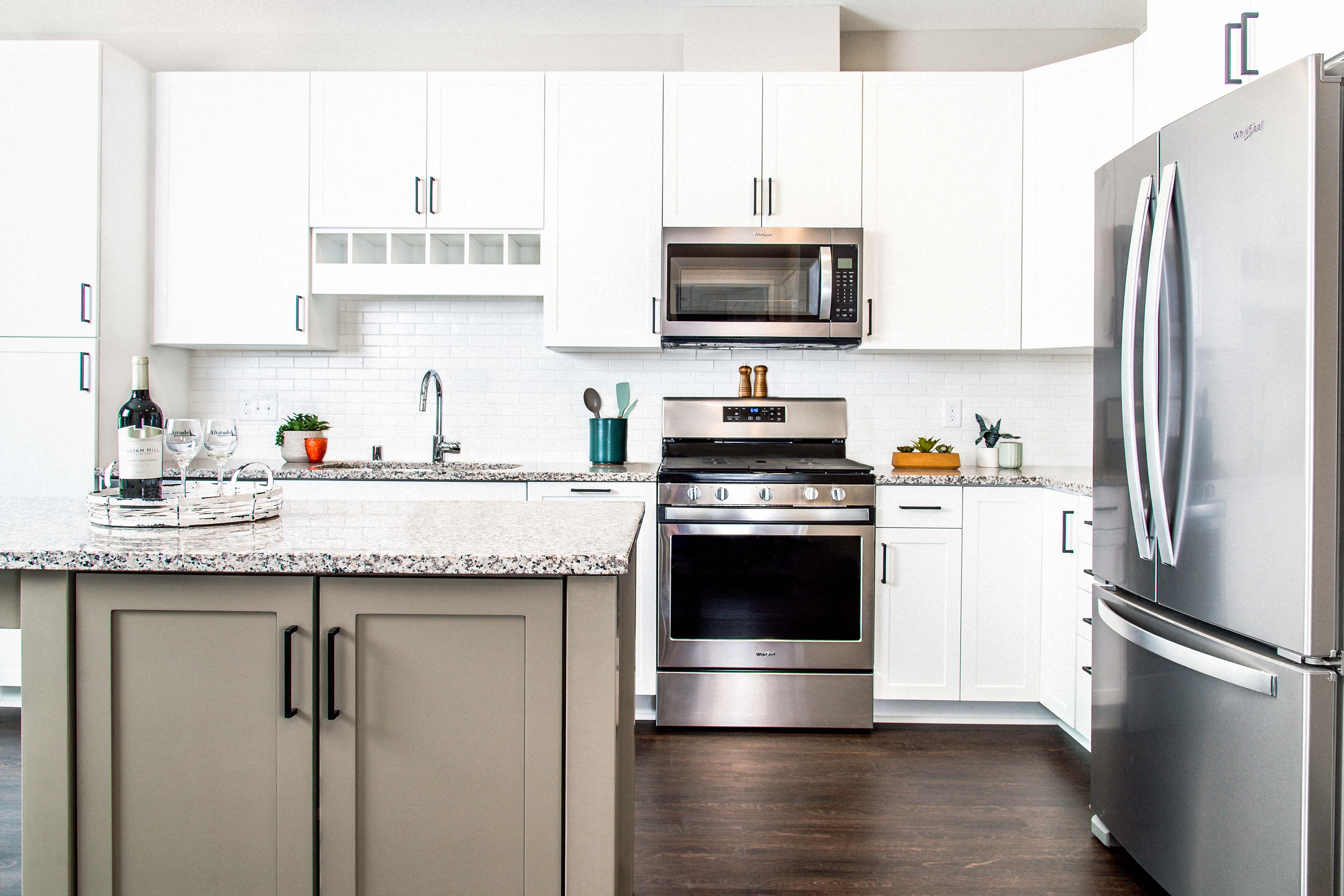 Modern kitchen with sleek stainless steel appliances, granite countertops, a built-in dishwasher, and a stylish gas range. Minnetonka, MN.