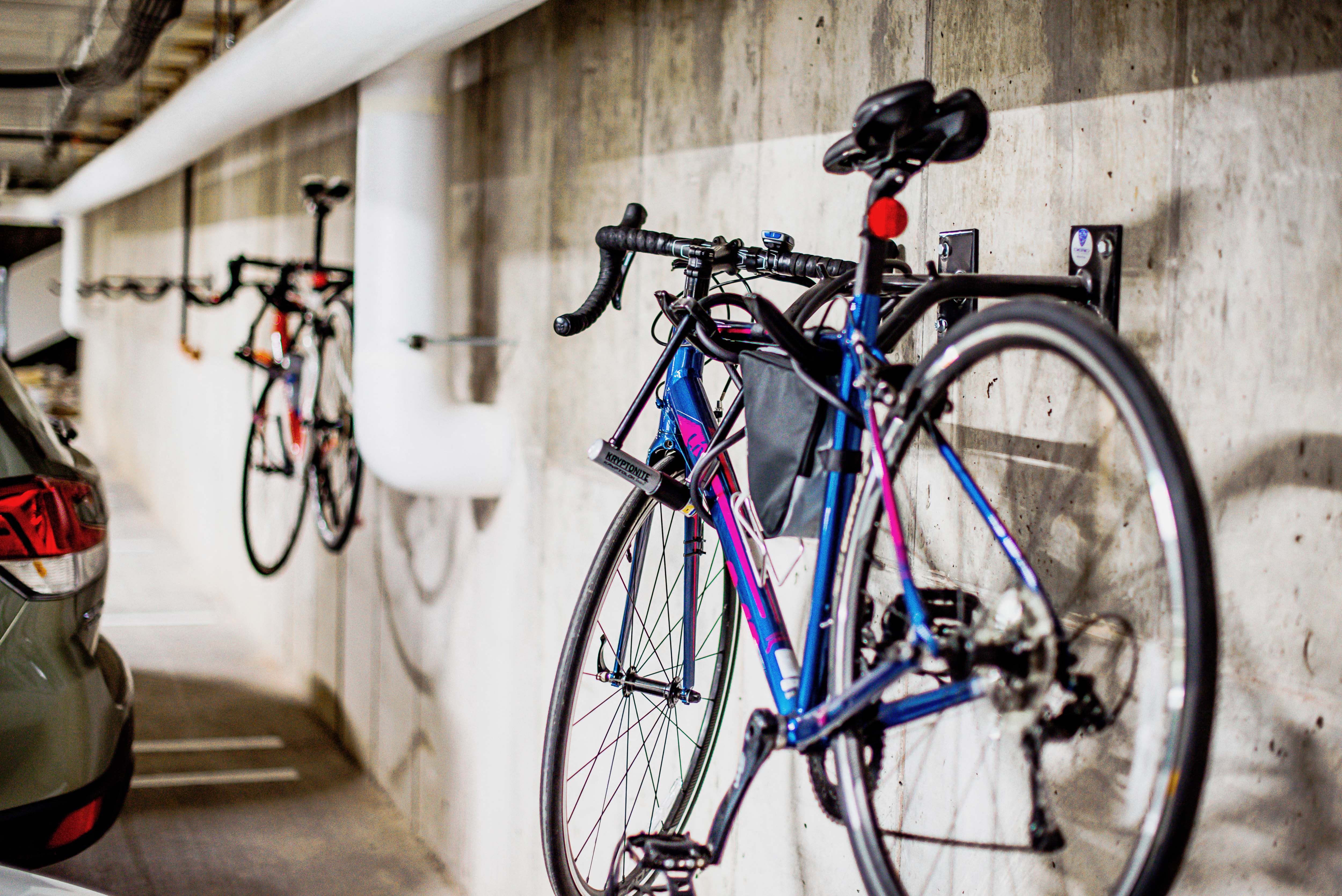 Underground parking lot at the modern apartment complex, featuring state-of-the-art electric vehicle chargers and bike racks for each assigned parking spot. A well-lit and spacious area with designated charging stations, ensuring convenience for residents with electric cars.