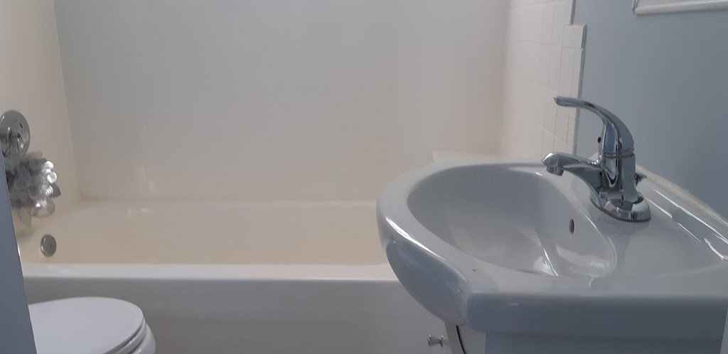 a bathroom with a sink and a bath tub