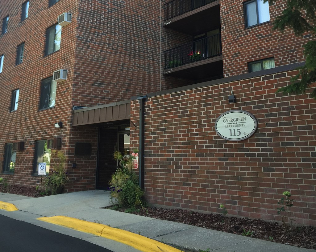 a brick building with a sign on the side of it