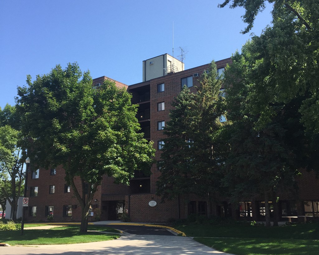 a red brick building with trees in front of it