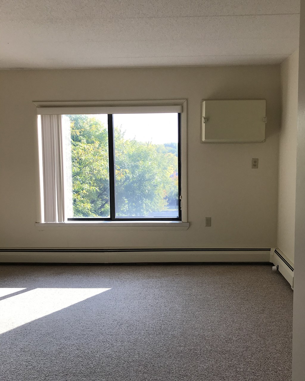 an empty living room with a large window