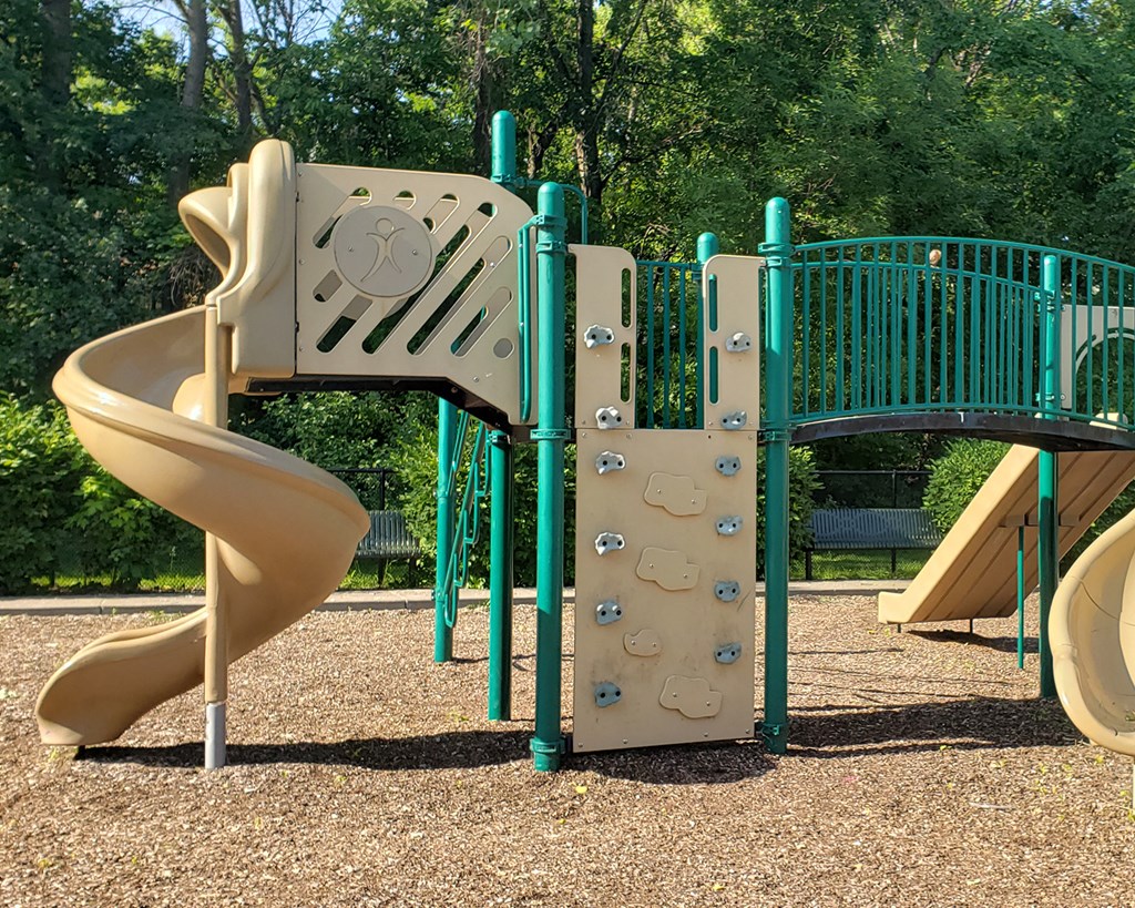 a playground with a slide and a climbing structure