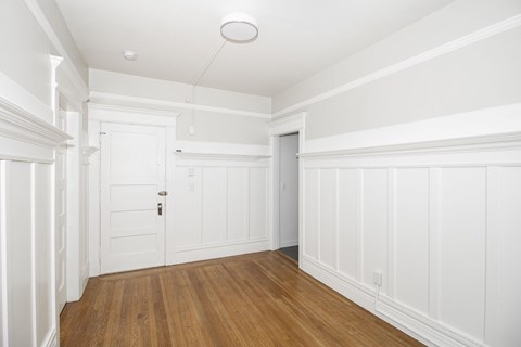 A room with white walls and wood flooring.