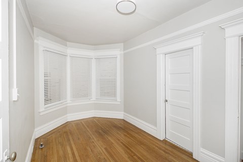 A room with white walls and wooden flooring.