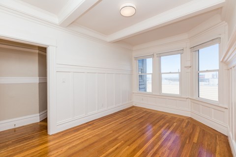 A room with wooden floors and white walls.