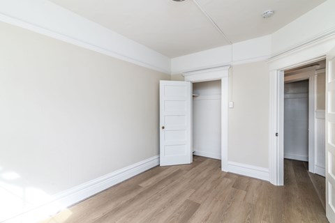 A room with a white door and a white cabinet.