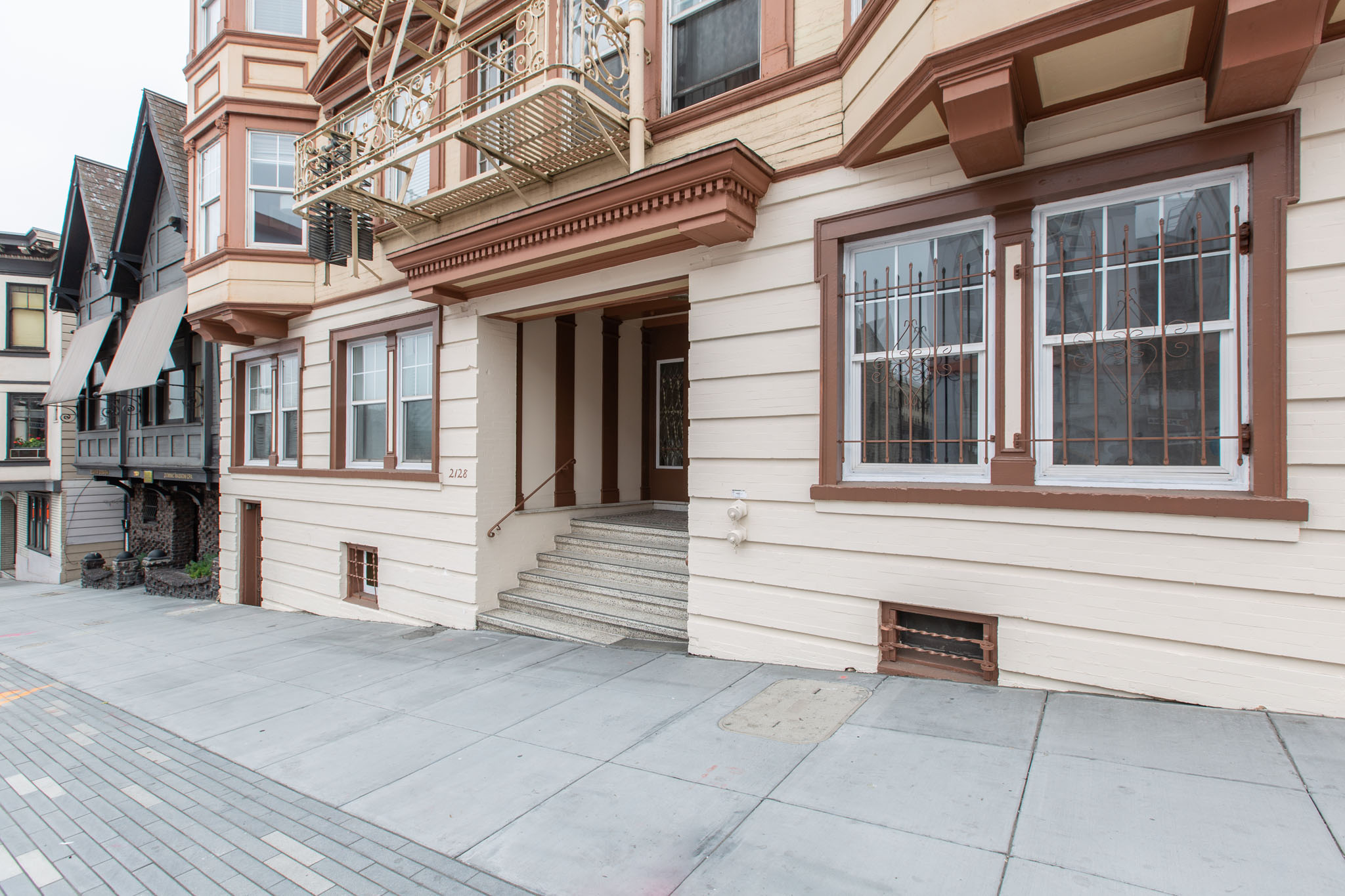 A building with a balcony and a door.