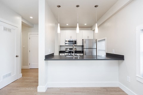a kitchen with a counter top and a refrigerator