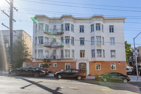 A black car is parked on the side of the street.