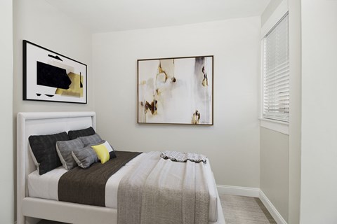 a bedroom with a bed and a painting on the wall