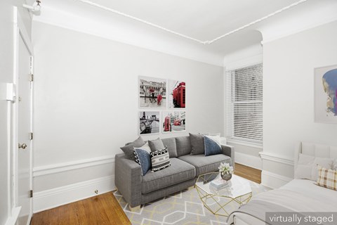 A living room with a grey couch and a coffee table.