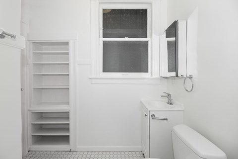 a small bathroom with a sink and a window