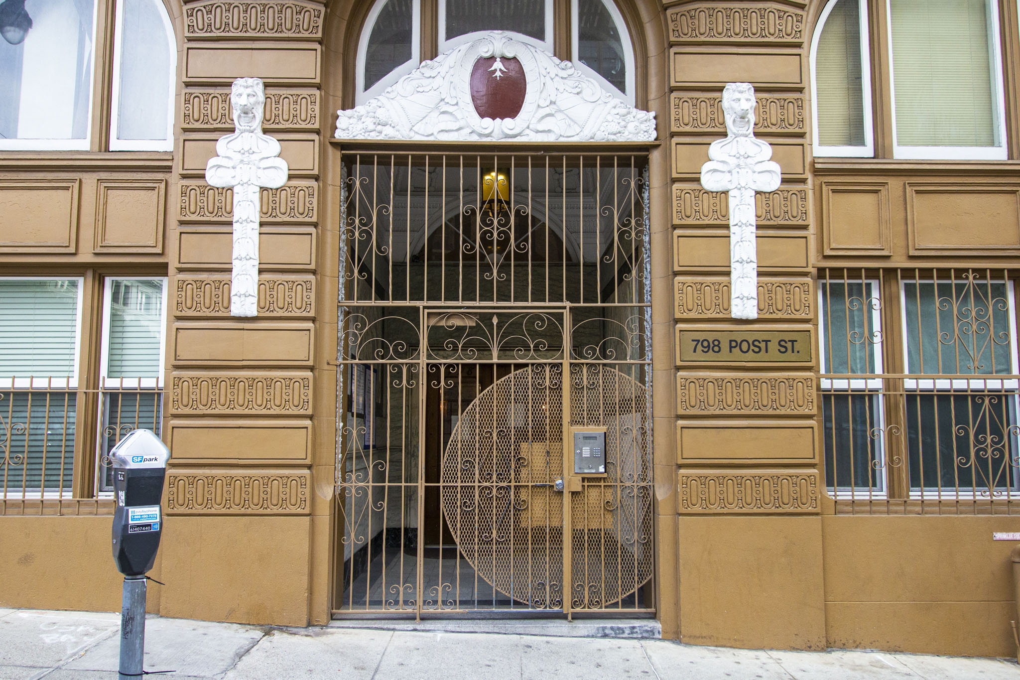A building with a large gate and a cross on it.