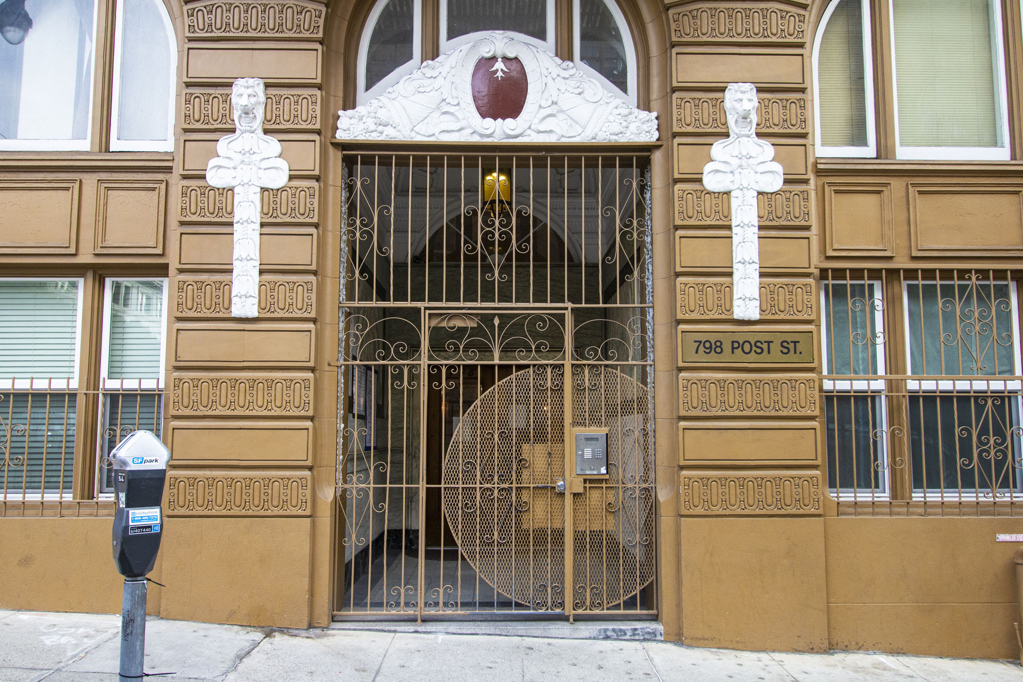 A building with a large gate and a sign that says 798 Post St.