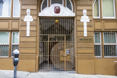 A building with a large gate and a sign that says 798 Post St.