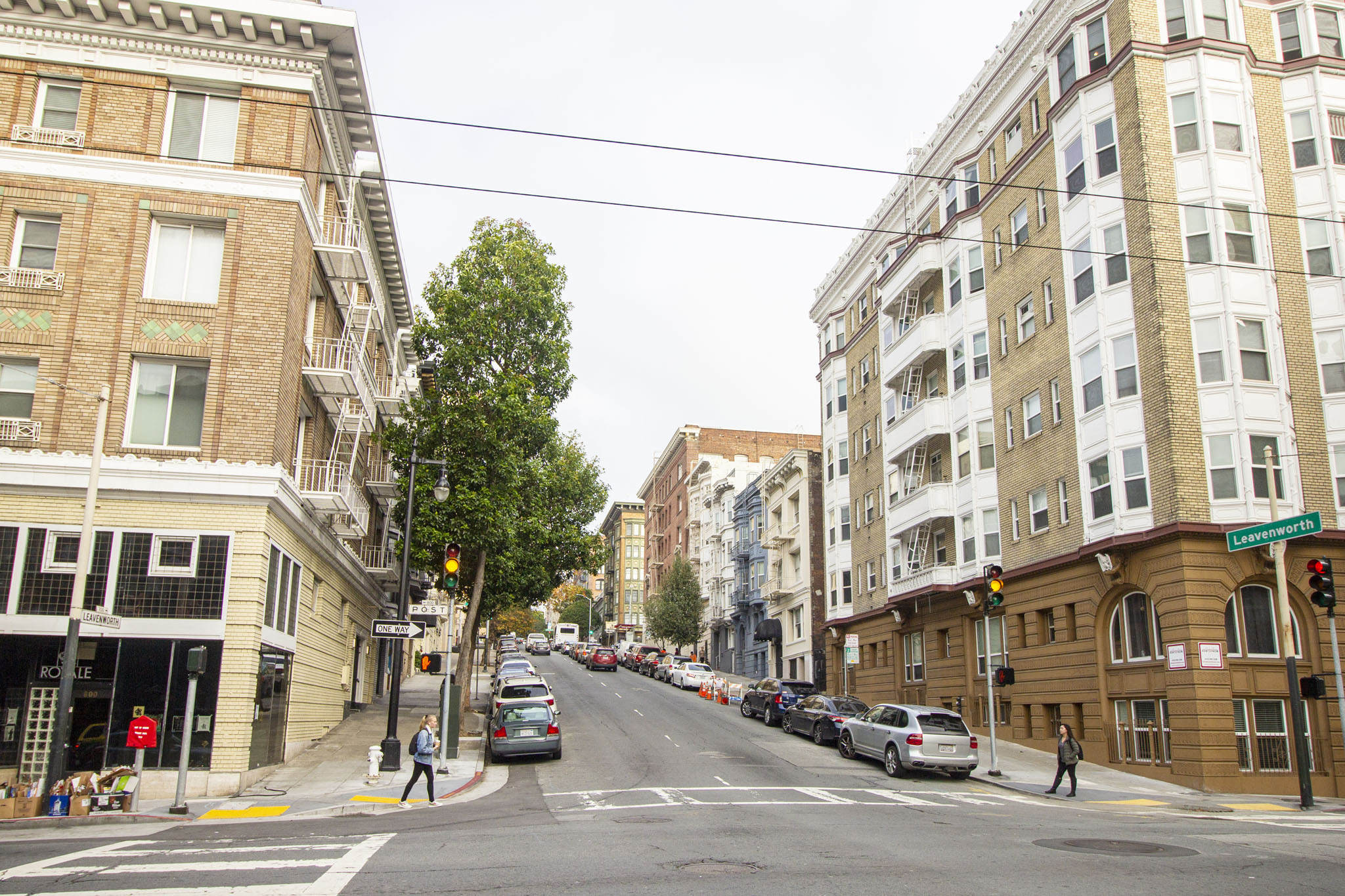 A street scene with cars and buildings on either side.