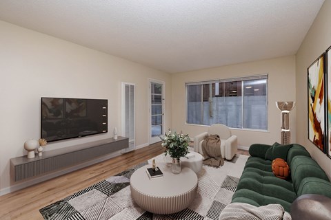 A living room with a television, a couch, and a coffee table.