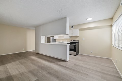 A kitchen area with a white countertop and a microwave above it.