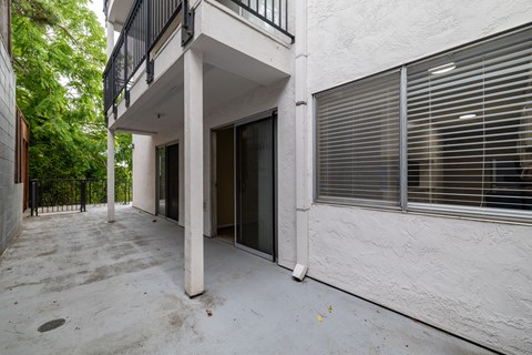 A white building with a balcony and a door.