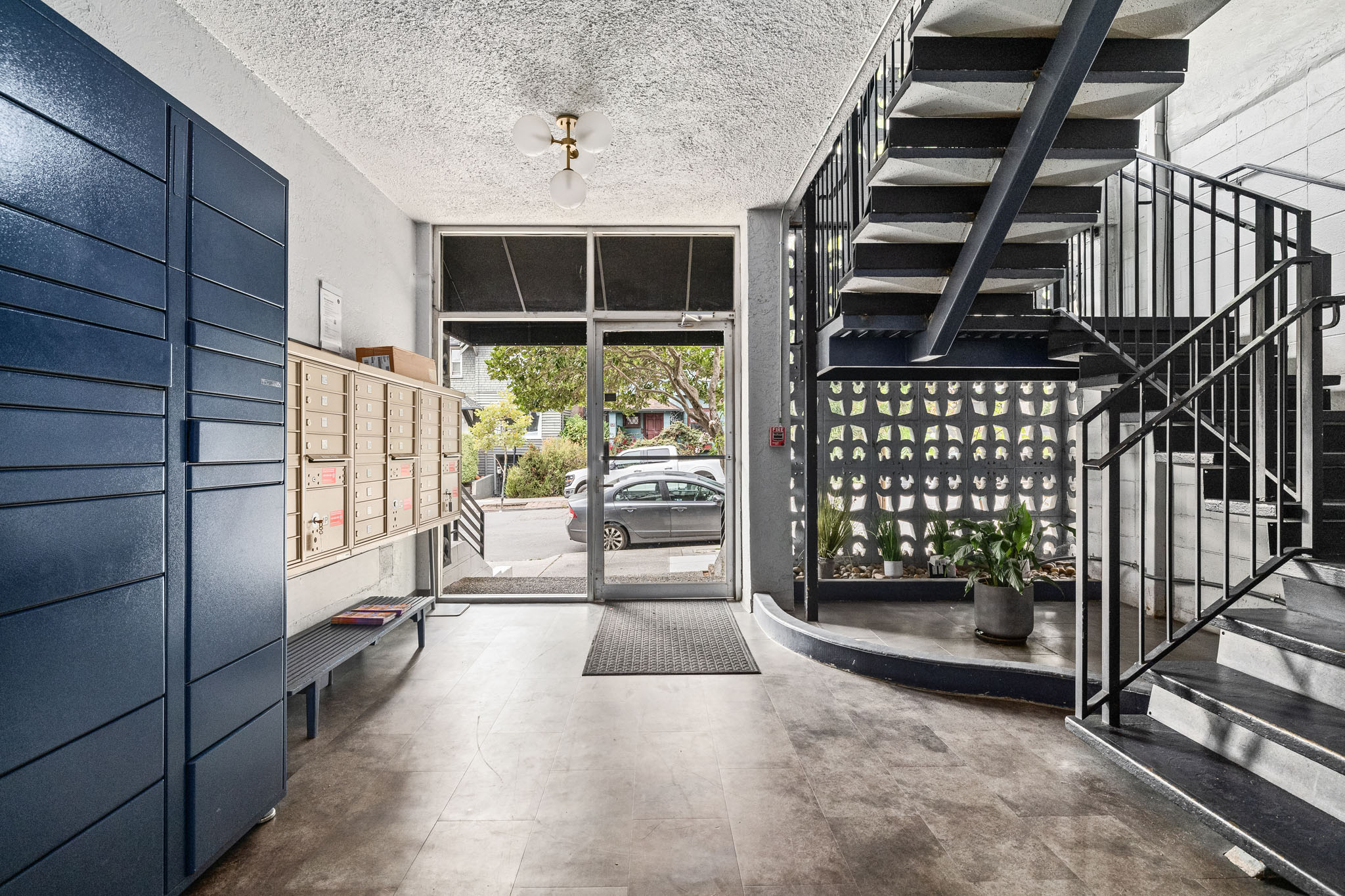A modern house entrance with a staircase and a glass door.