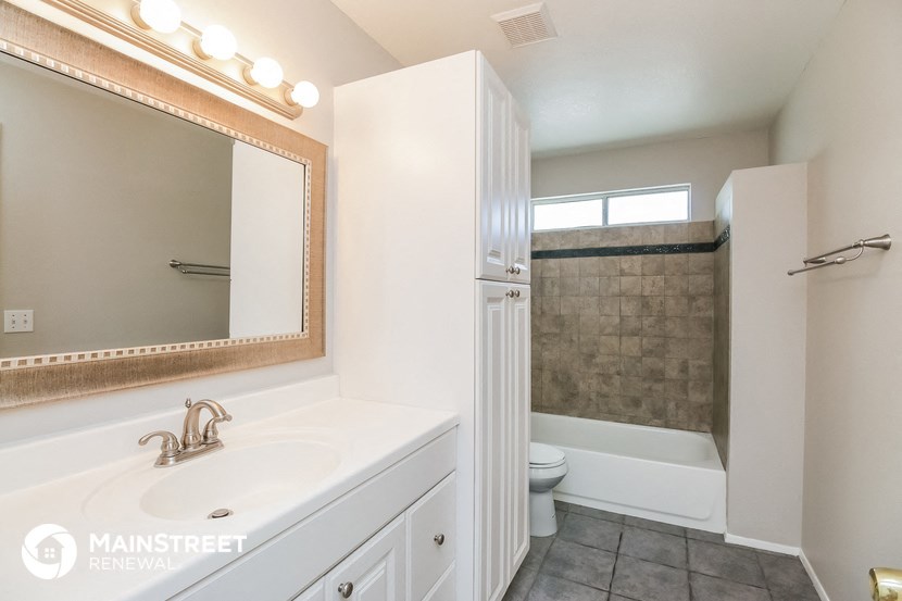 a bathroom with a sink and a shower and a toilet