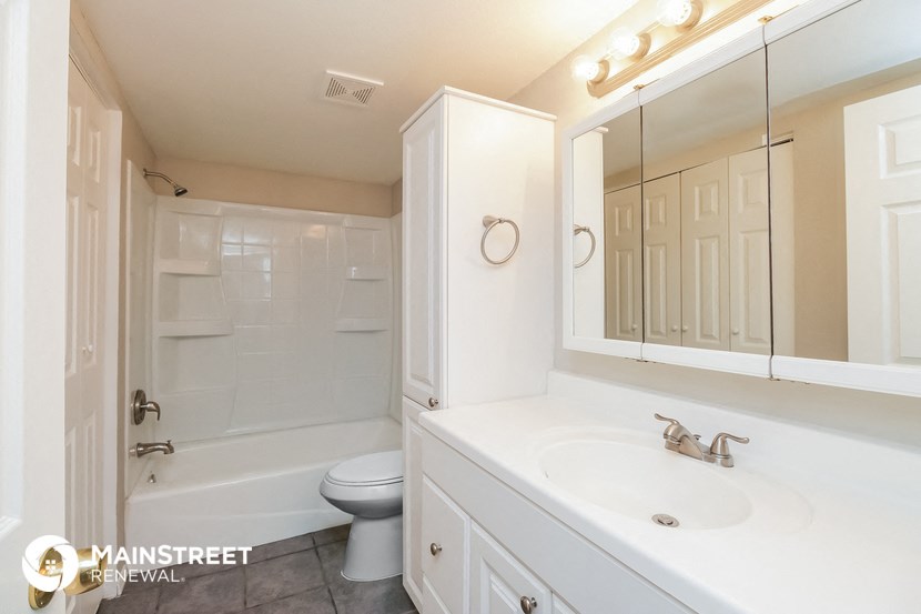 a white bathroom with a sink and a toilet