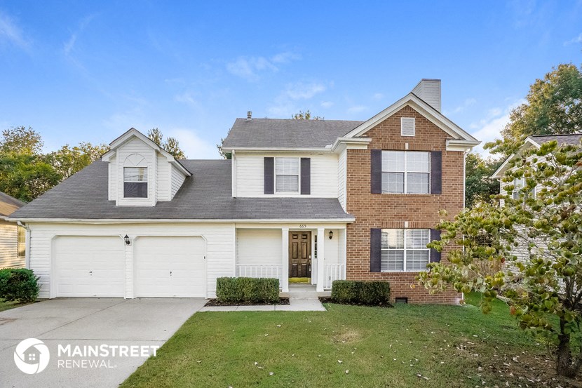 a brick and with a white garage door