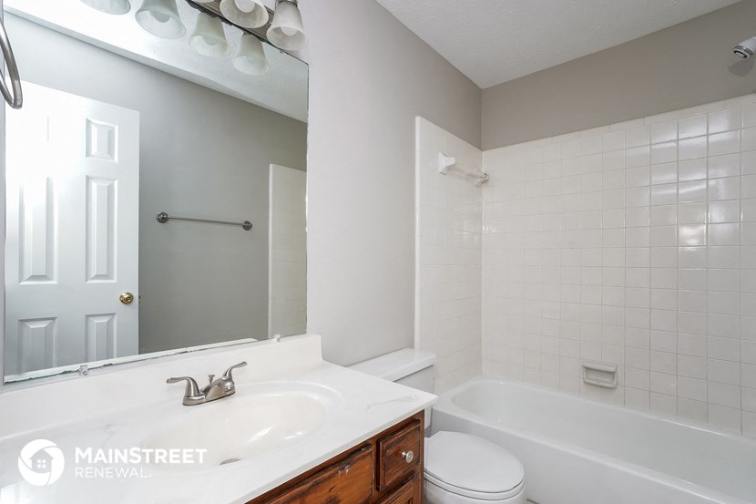 a bathroom with a sink and a tub and a mirror
