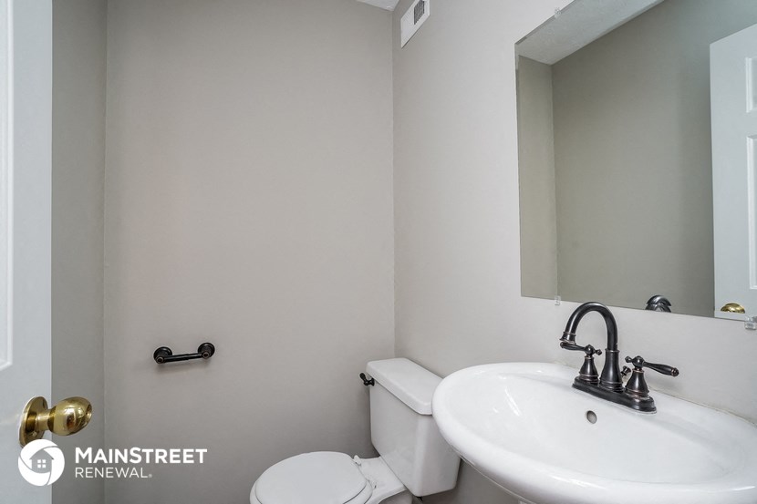 a bathroom with a sink and a toilet and a mirror