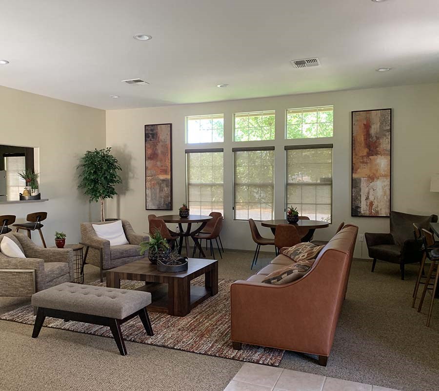 Community room with seating and windows at COURTYARDS @ PENN VALLEY, PENN VALLEY California