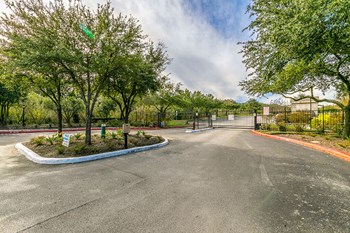Gated community entrance with trees and circle drive - Photo Gallery 39