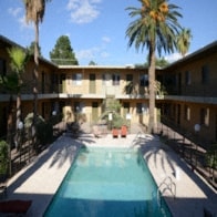 the pool is surrounded by palm trees at the inn of the governors