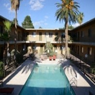 the pool is surrounded by palm trees at the inn of the governors
