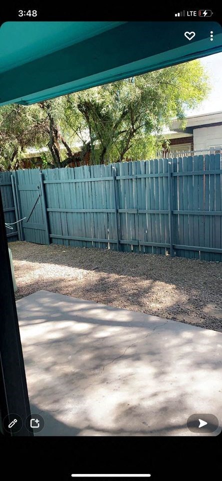 a view of a blue fence from a car window