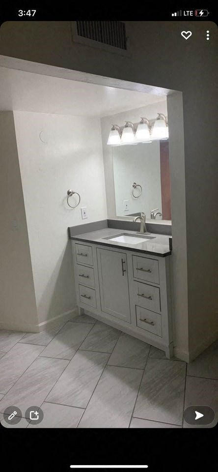 a bathroom with a sink and a mirror