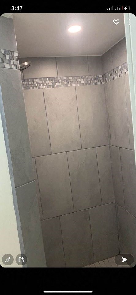 a bathroom with a tiled floor and a shower