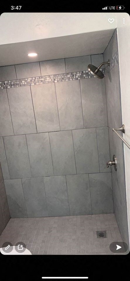 a tiled shower in a bathroom with a shower head